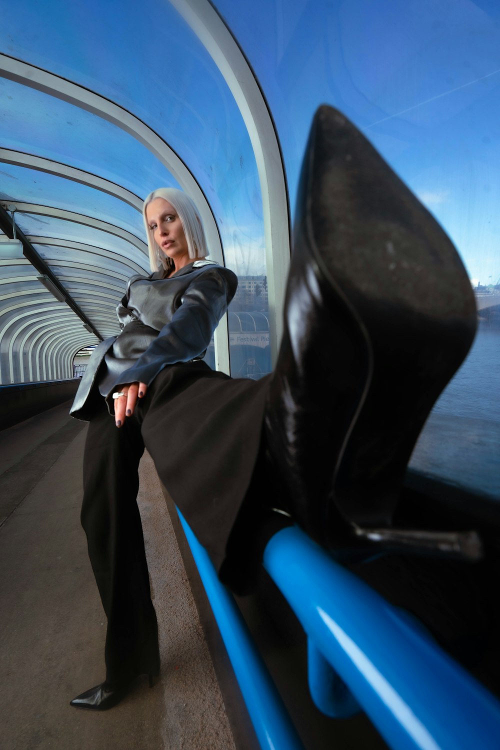 a woman sitting on a bench in a tunnel