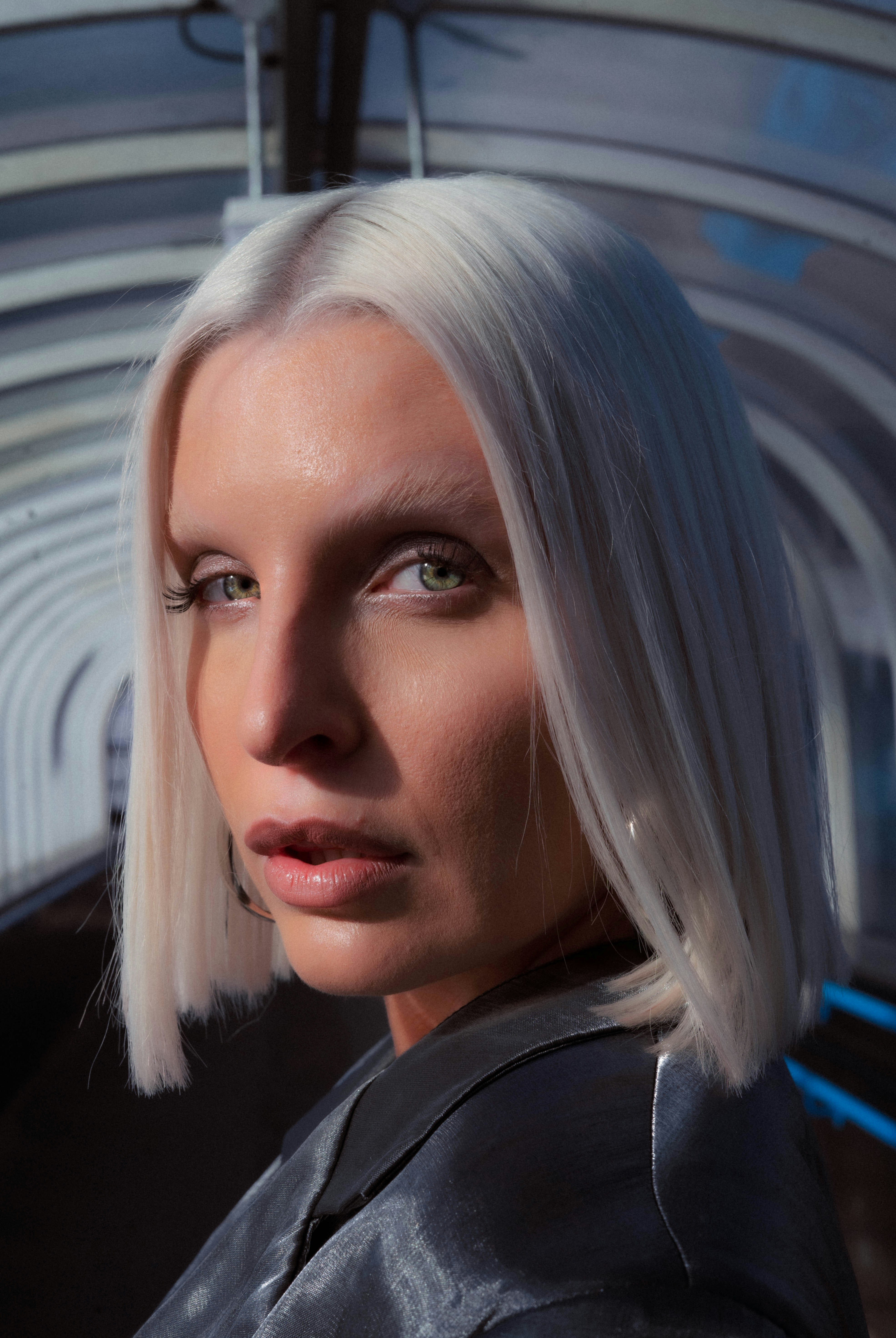 A woman with a platinum blunt bob whose hemline sits exactly at her jaw
