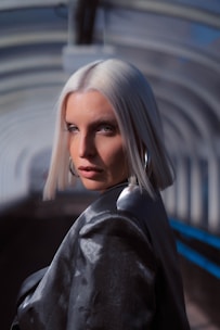 Close-up of a woman with shiny platinum blonde hair styled elegantly.