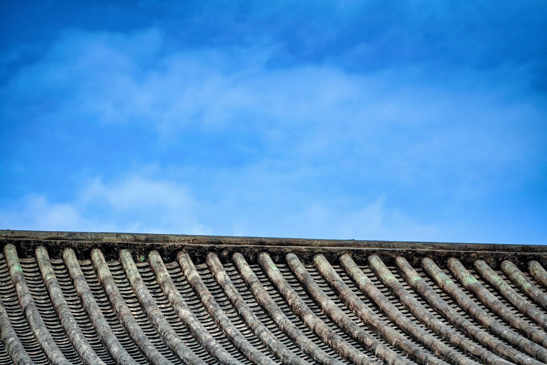 woman wearing yellow long-sleeved dress under white clouds and blue sky during daytime