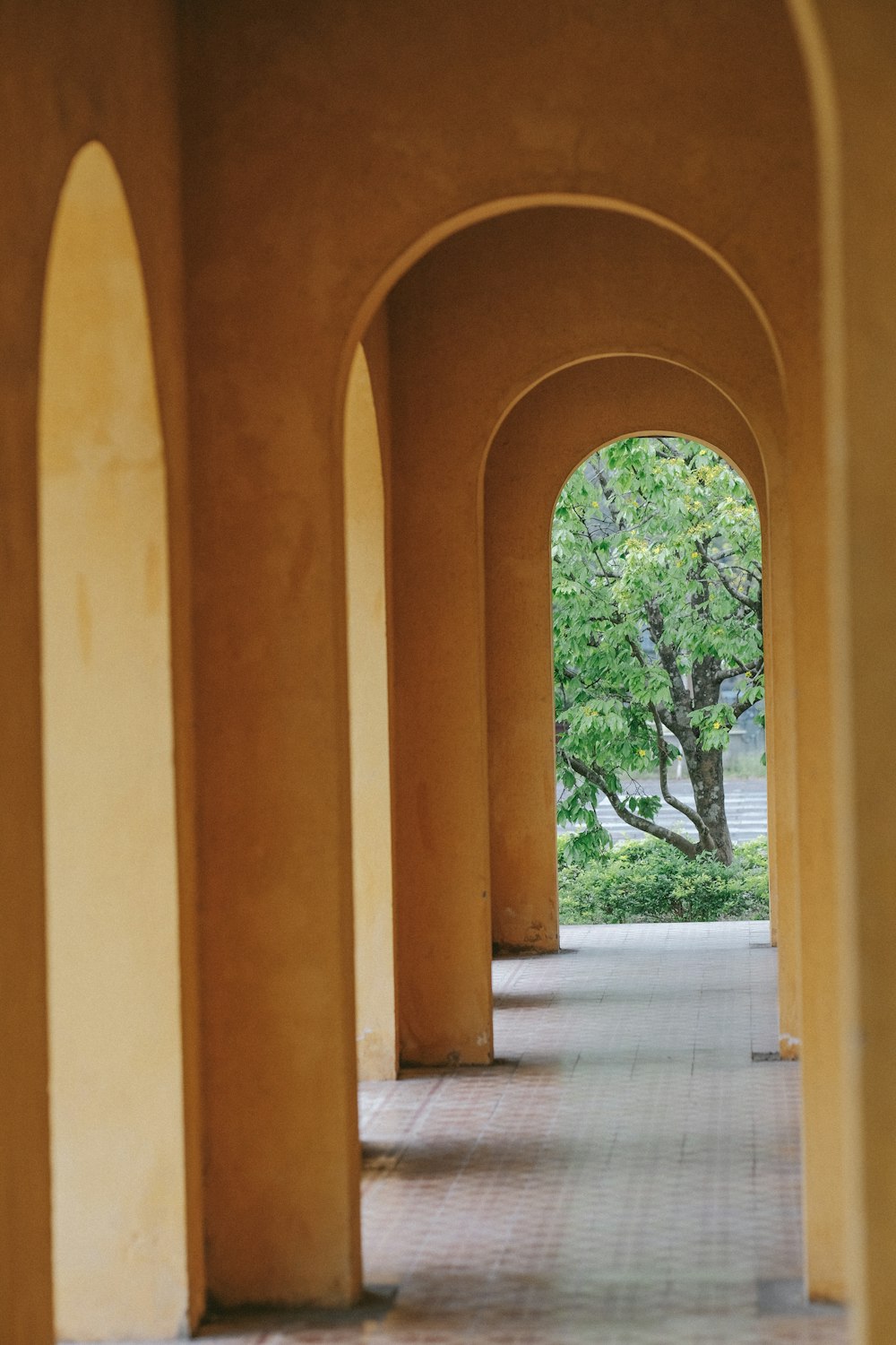a row of archways with trees in the background