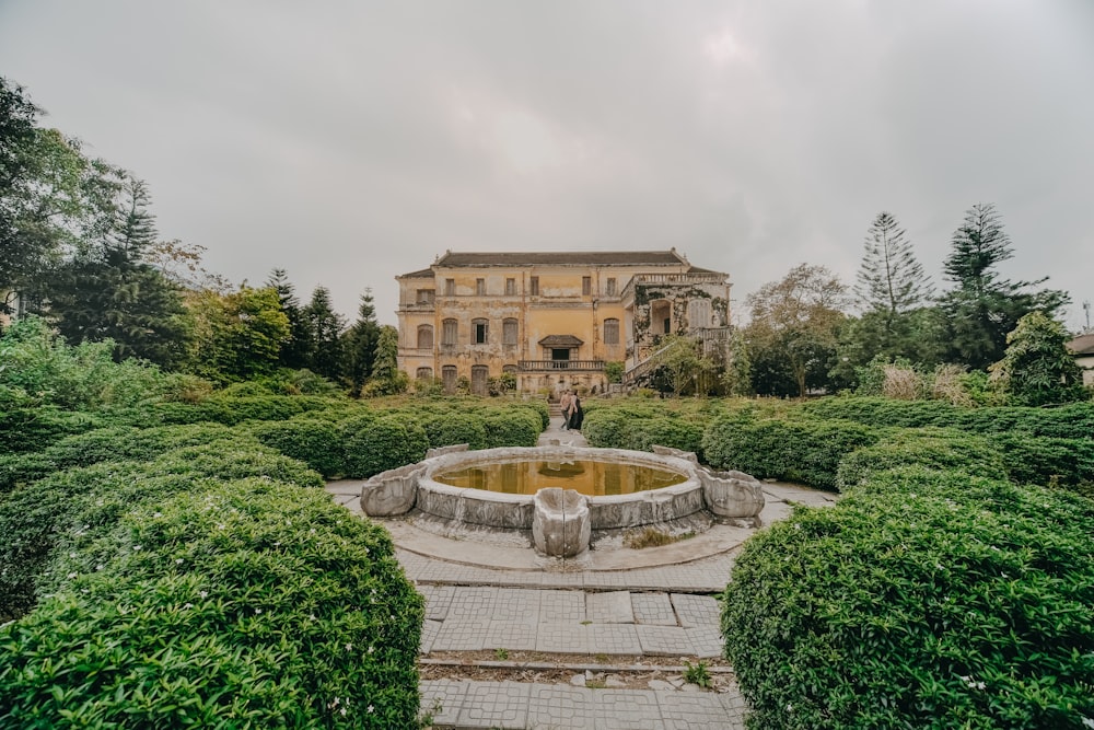 a large building with a fountain in front of it