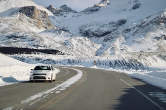 Luxy Limousine vehicle driving through snowy mountain roads near Verbier ski resort.