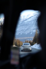 A taxi driving along a scenic mountain road.