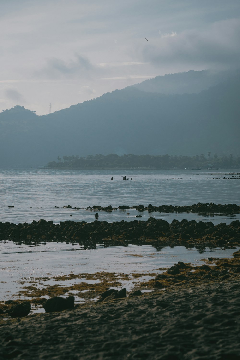 a body of water with mountains in the background