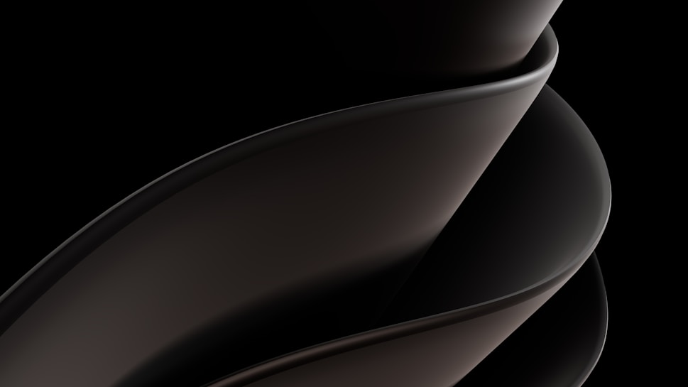 A sleek, smooth, and abstract form consisting of overlapping curved surfaces, primarily in dark tones and gradients. The design is fluid and modern, suggesting movement and elegance.