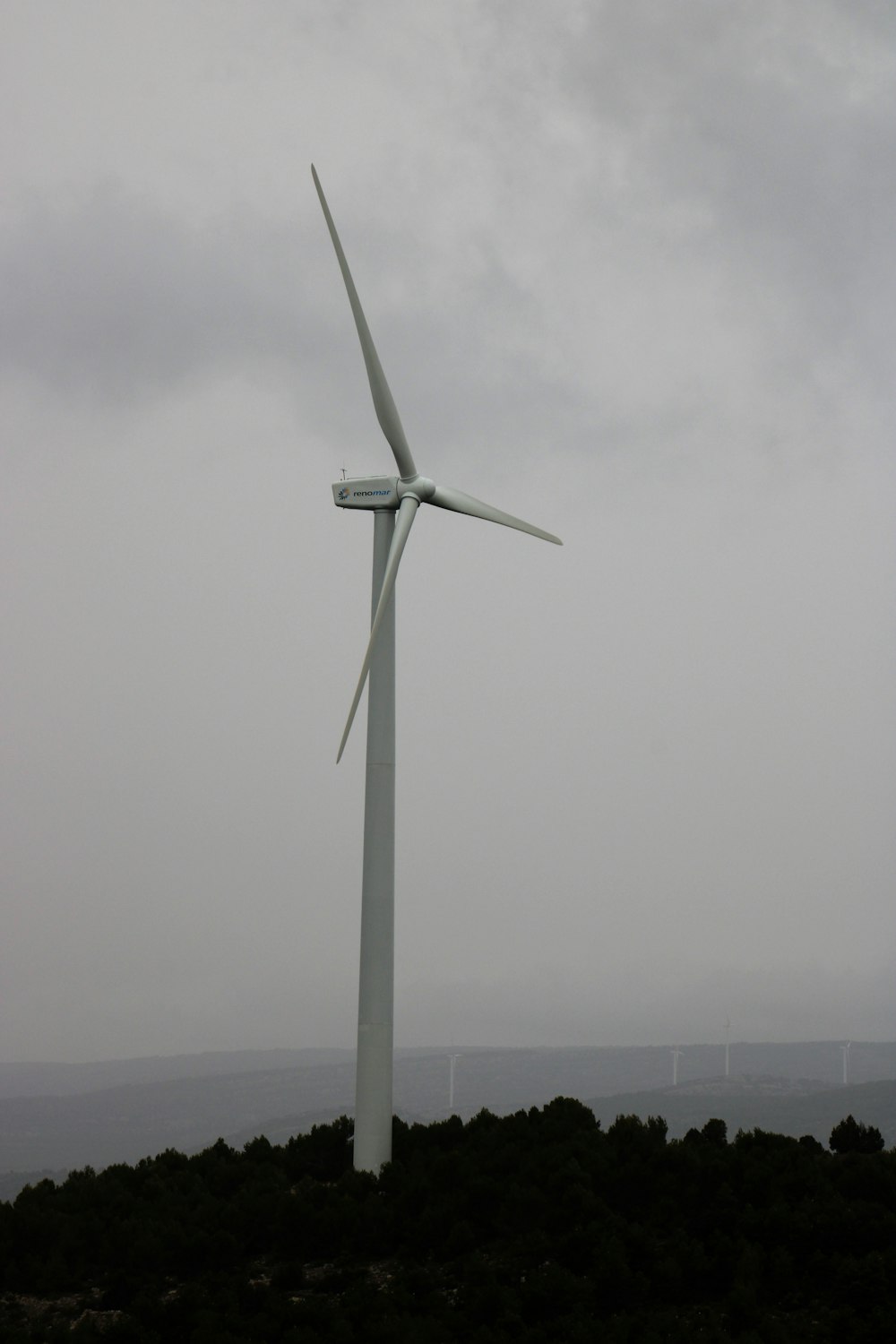 a wind turbine on top of a hill