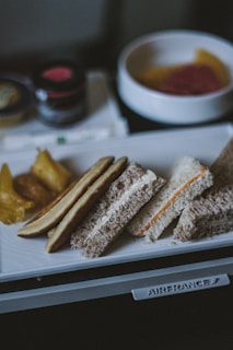 a white plate topped with sandwiches and pickles