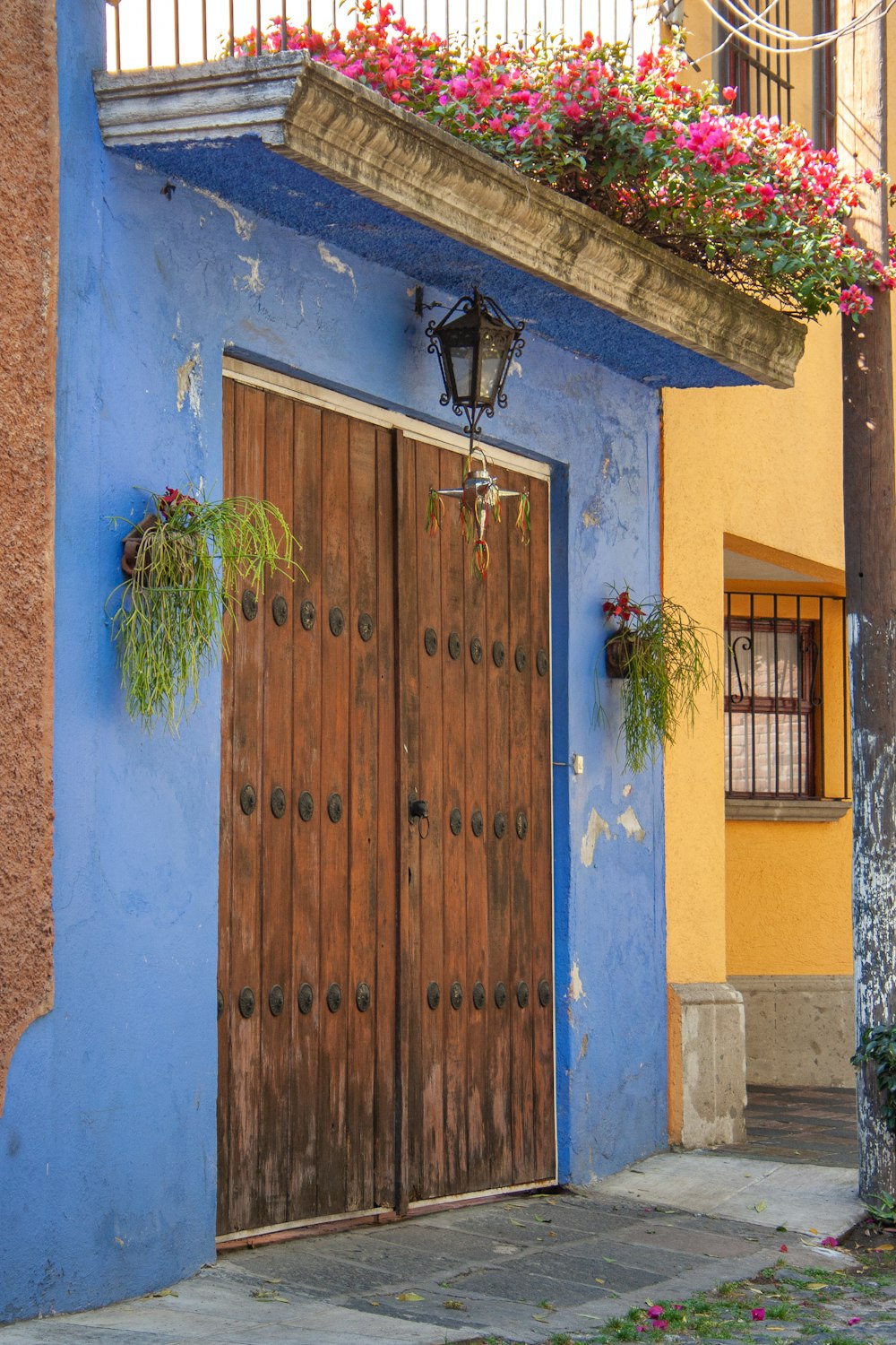 a blue building with a wooden door and window