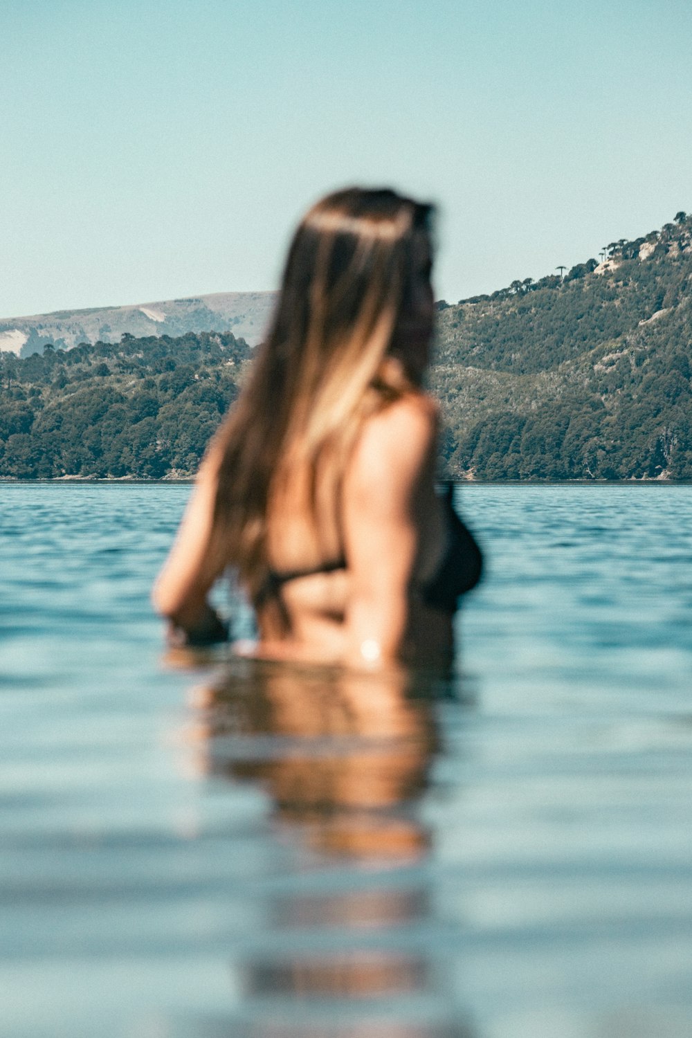 a woman in a bikini standing in the water