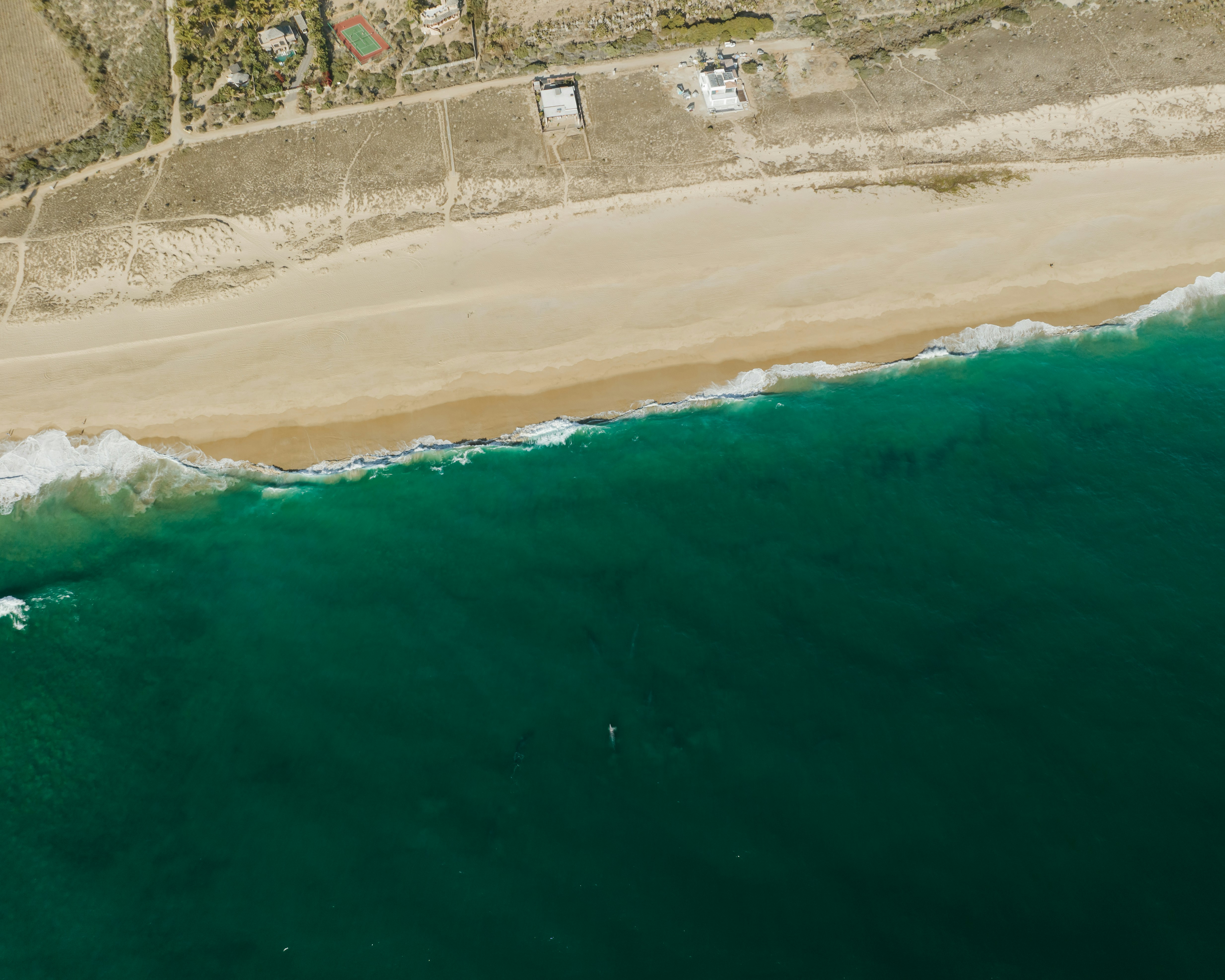 an aerial view of a beach and ocean, 