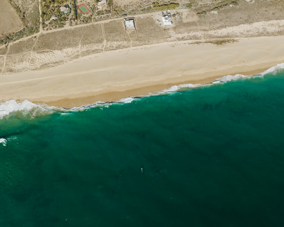 an aerial view of a beach and ocean,