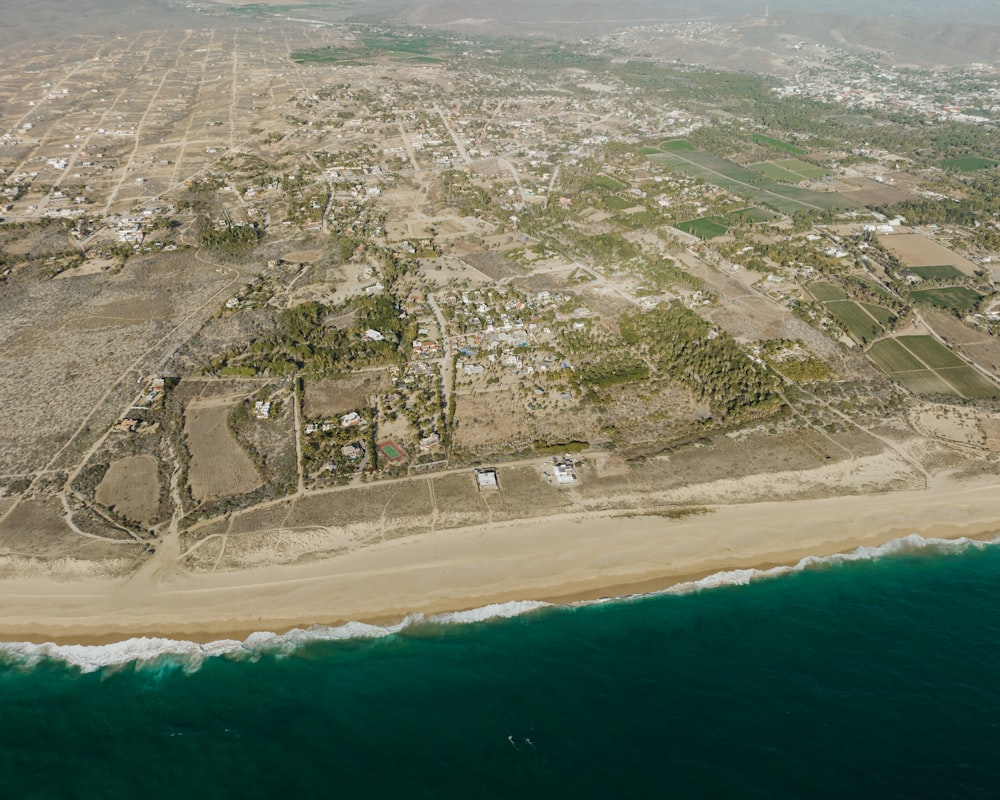 an aerial view of a beach and a city