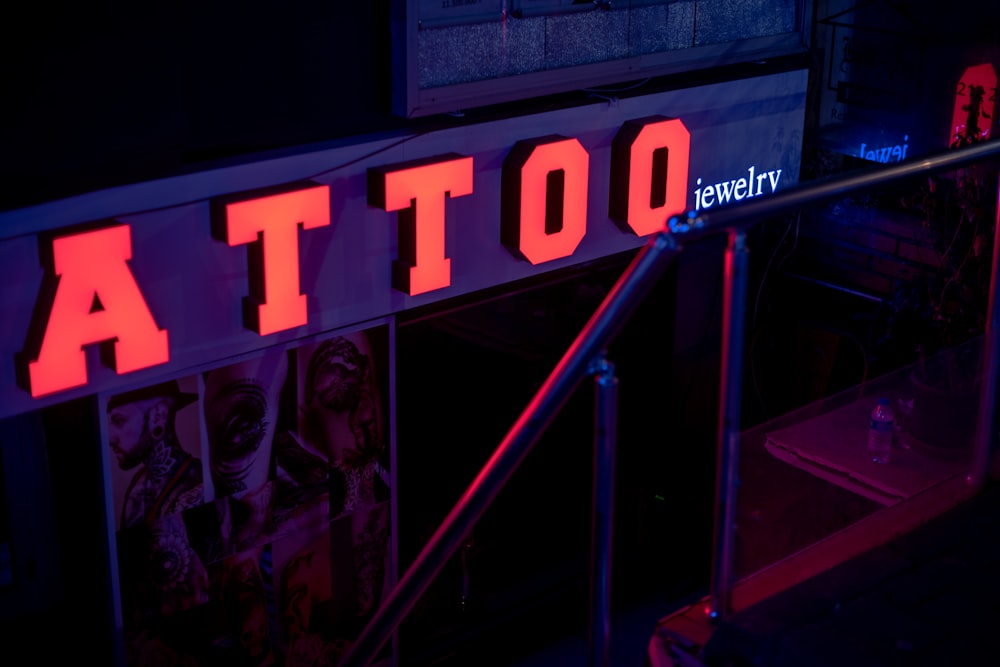 a lit up sign that says tattoo on it