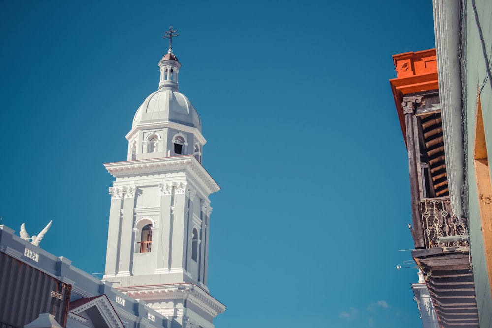 a tall white building with a clock on it's side