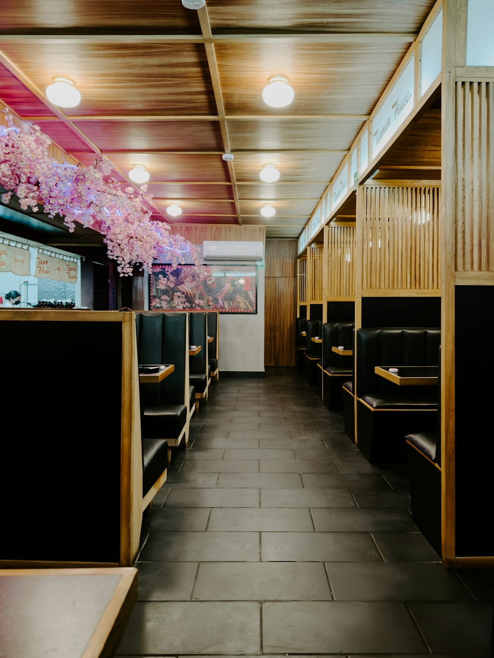 a restaurant with a long row of booths