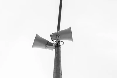 Graphic of a megaphone on a stand symbolizing event promotion and execution.