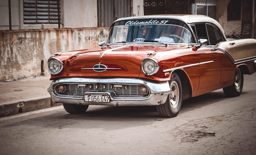 an old car is parked on the side of the road