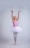 A joyful young girl in a pink ballet outfit practicing at the barre.