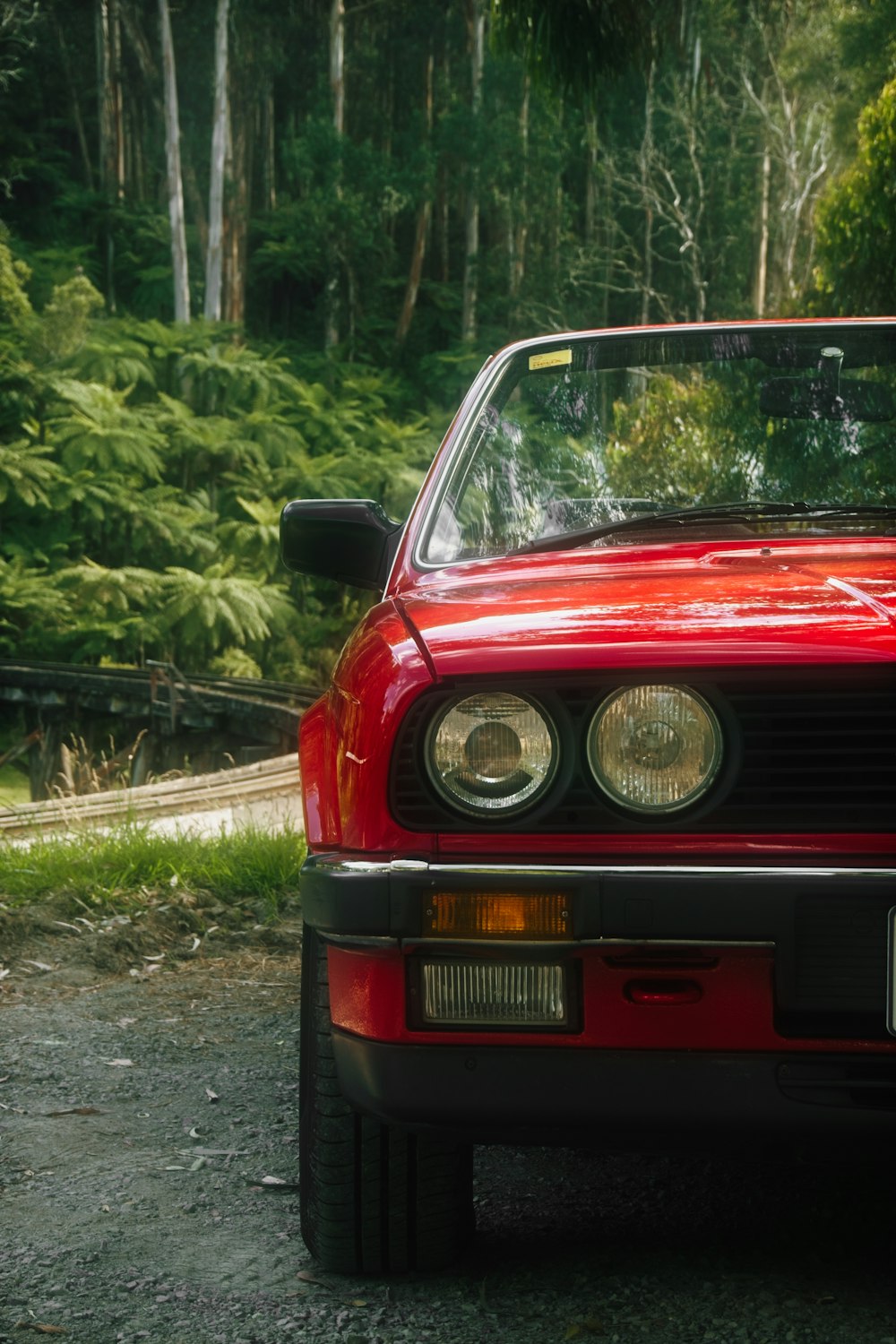 a red car parked on the side of a road