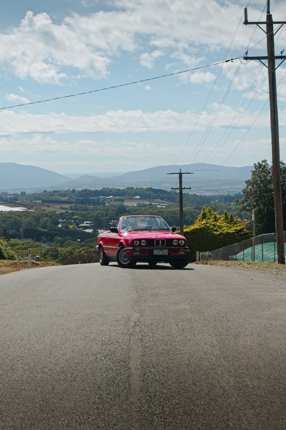 a red car parked on the side of a road