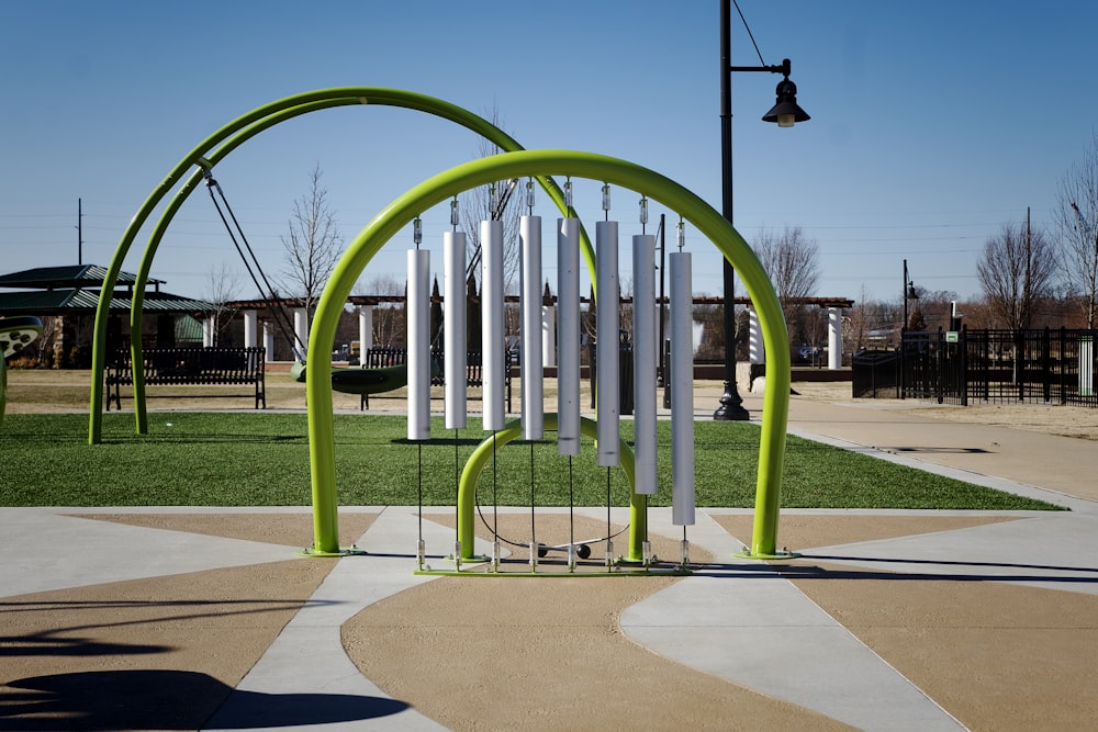 a green and white sculpture in a park