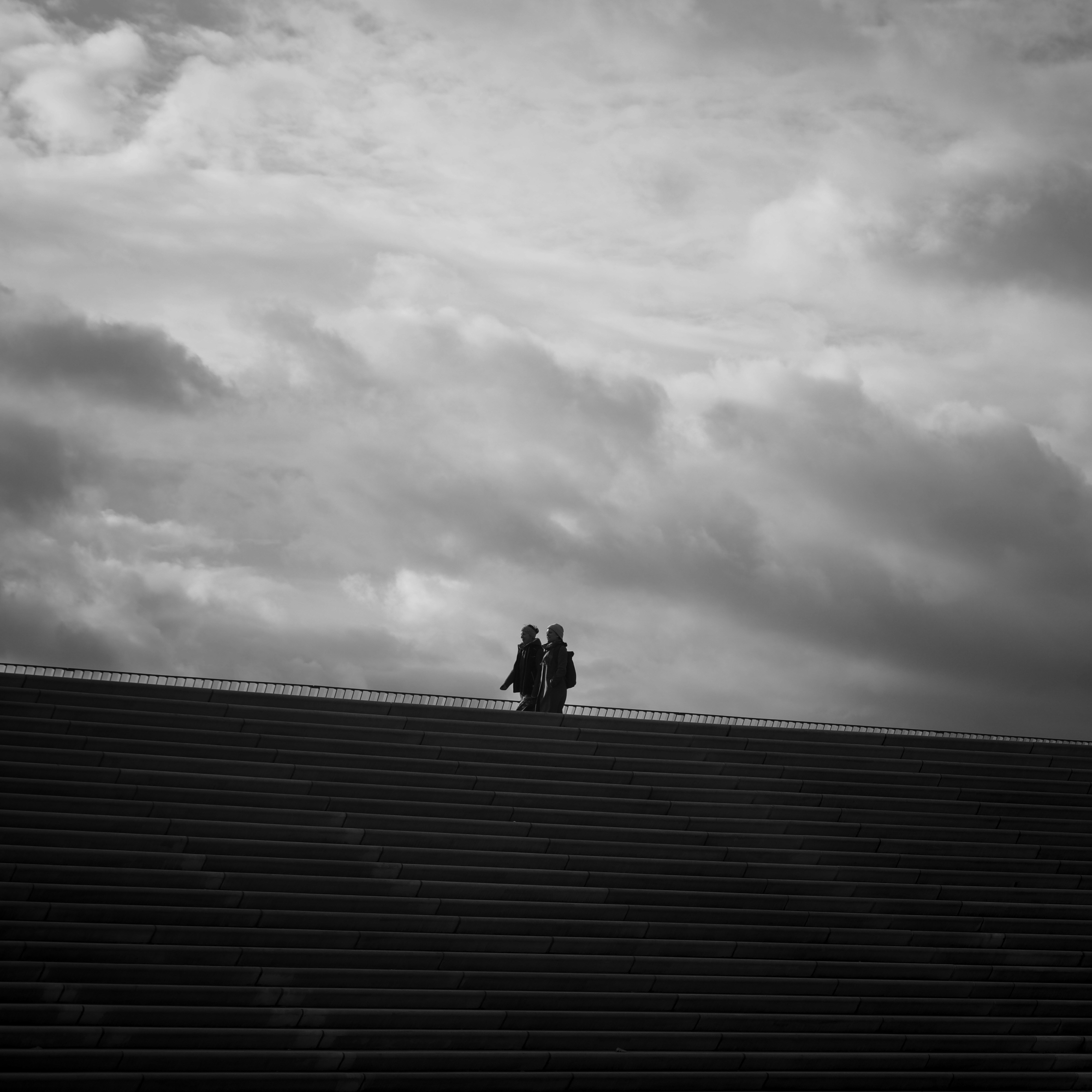 two people standing on a stadium bleachers