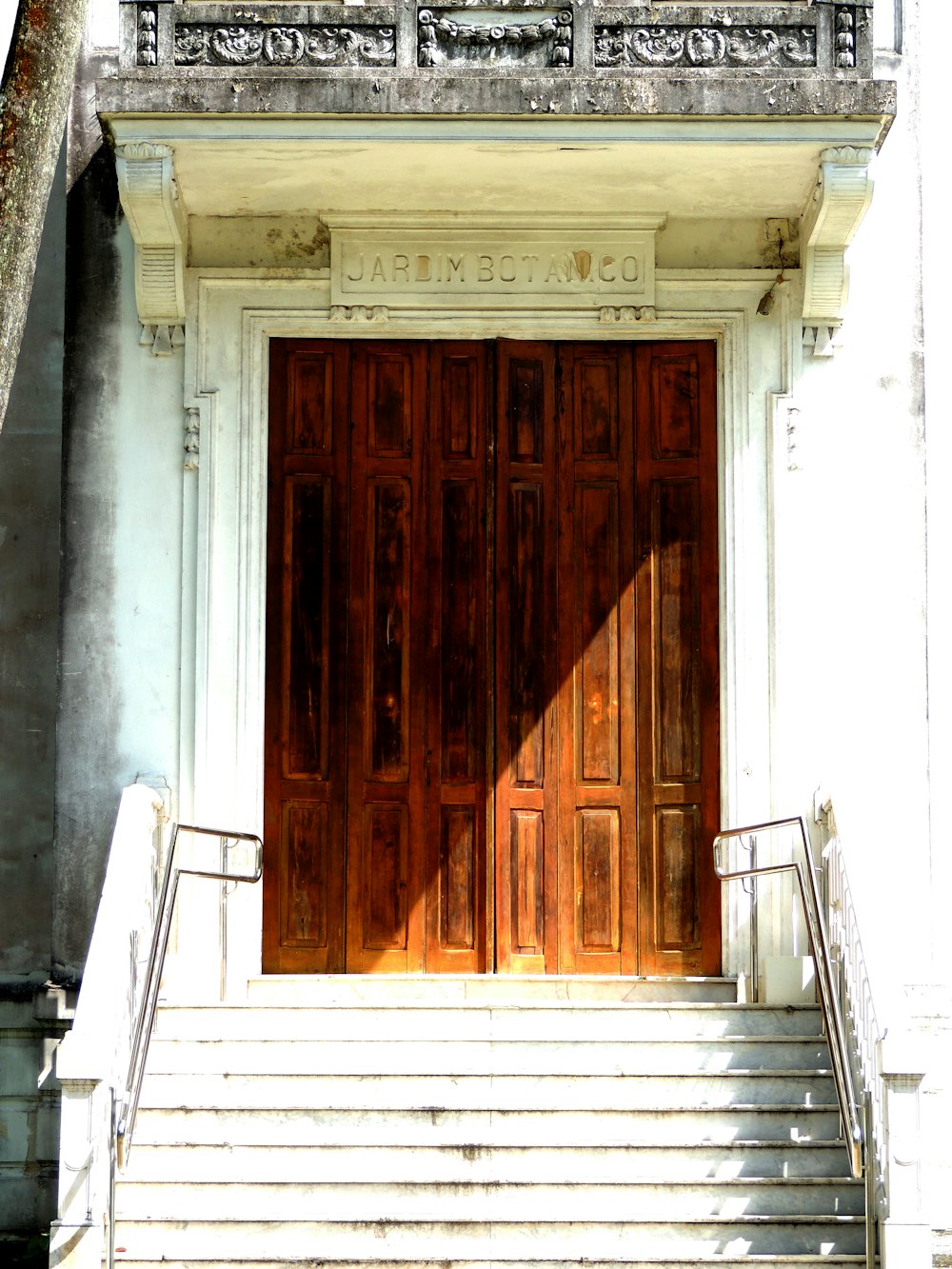 a large wooden door sitting next to a set of stairs