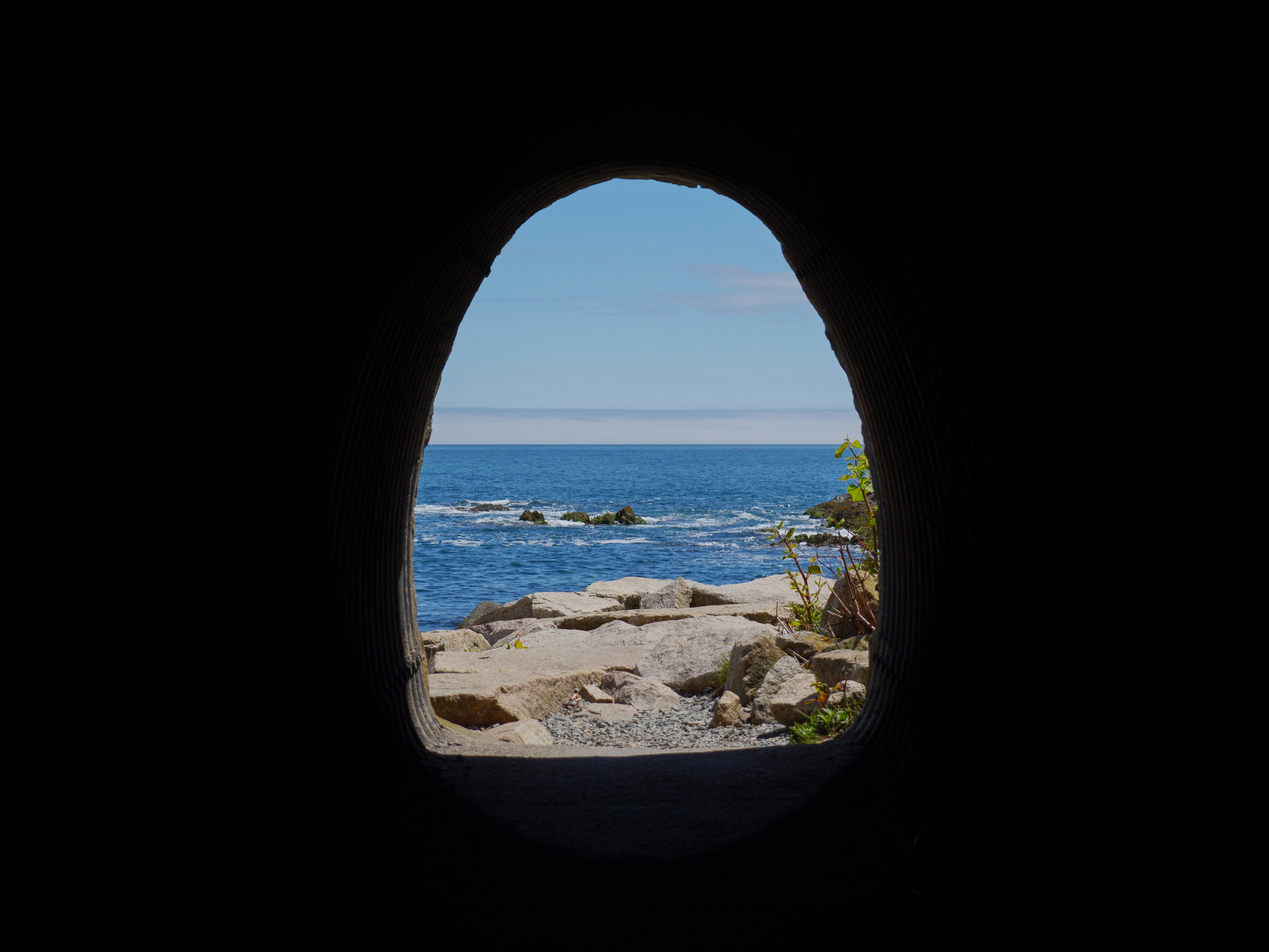 a view of a body of water from a cave, 