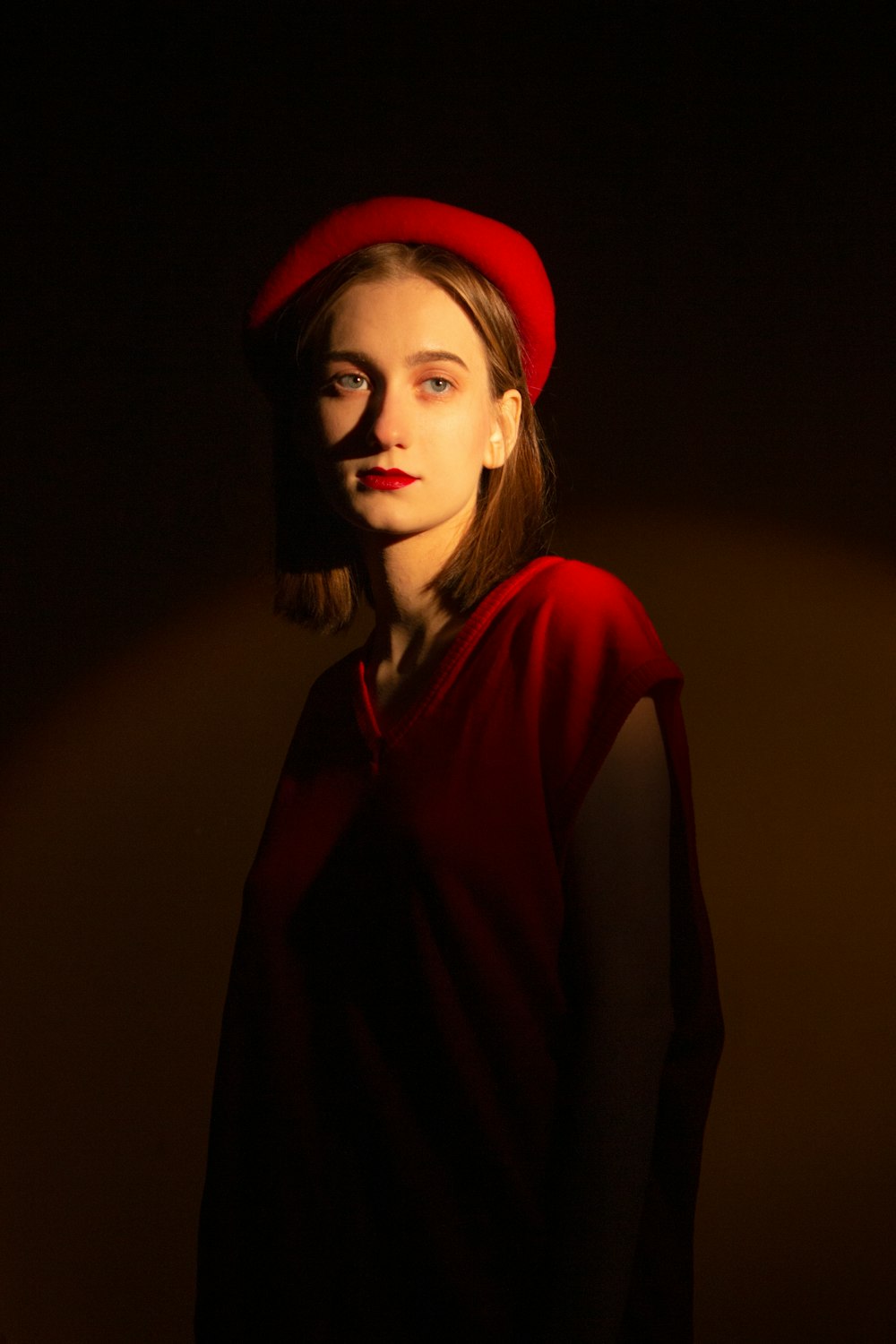 a woman wearing a red hat and a red dress