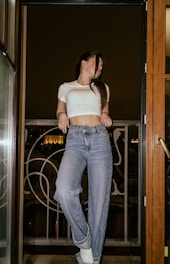 a woman standing in a doorway with her hands on her hips