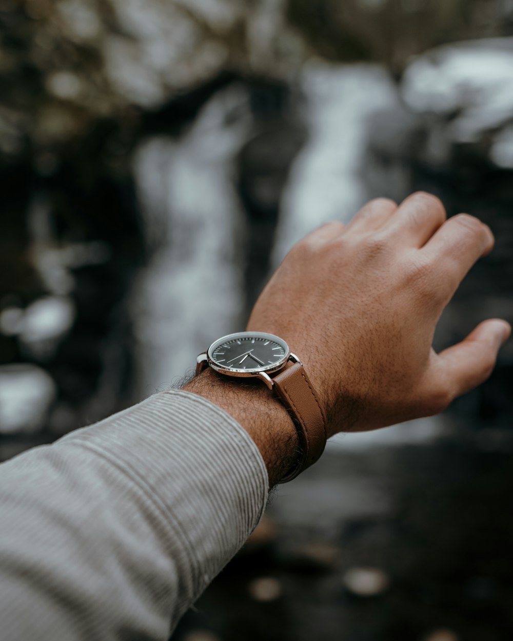 a man's hand with a watch on it