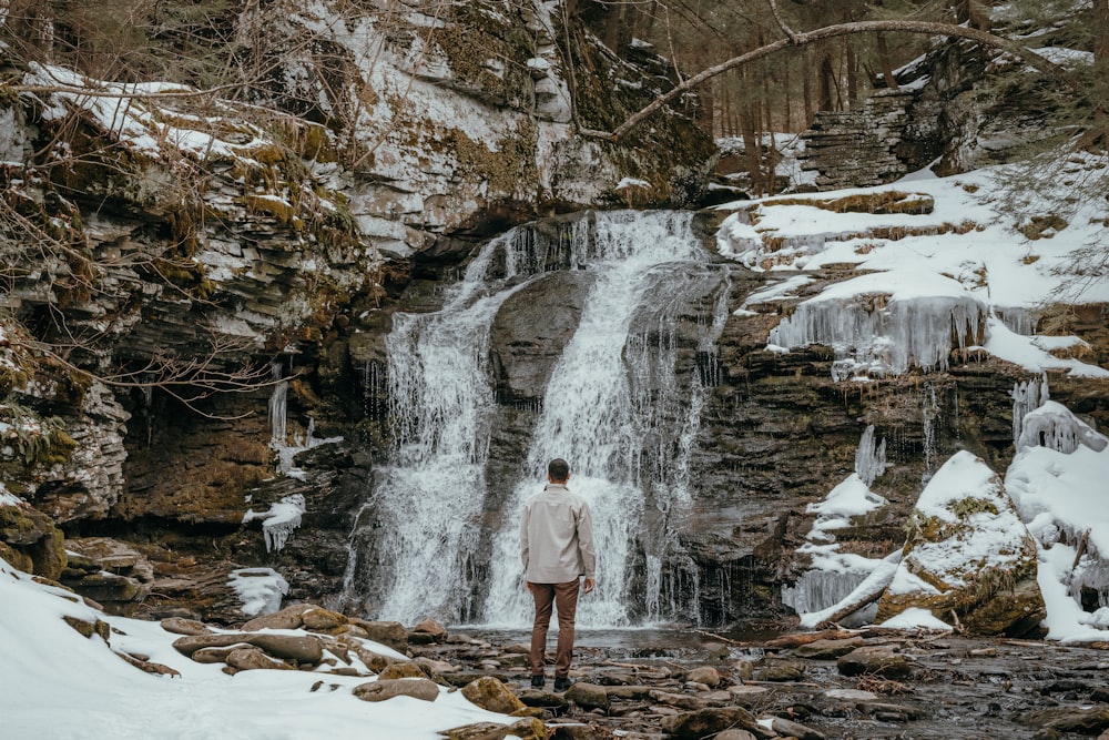 a person standing in front of a waterfall