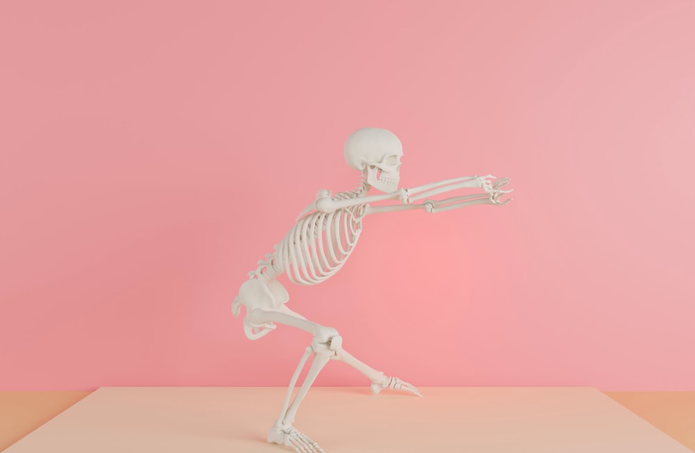 a skeleton is standing on one leg and pointing at something