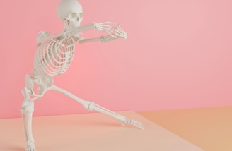 a skeleton is dancing on a pink background
