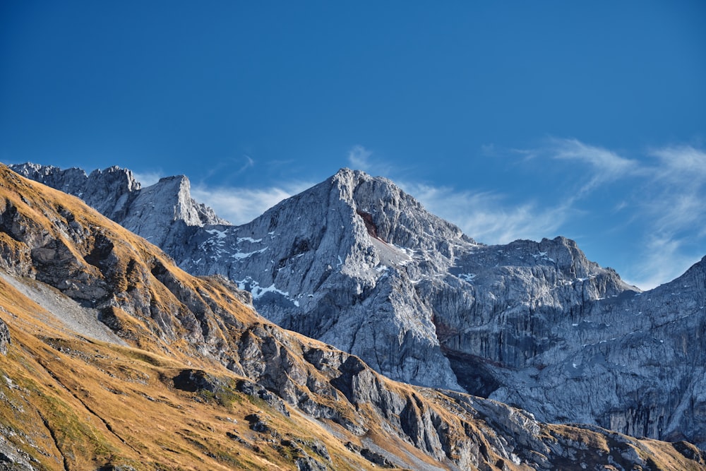 a view of a mountain range from the top of a hill