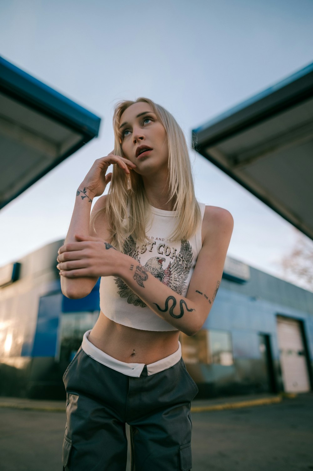 a woman with tattoos standing in front of a train