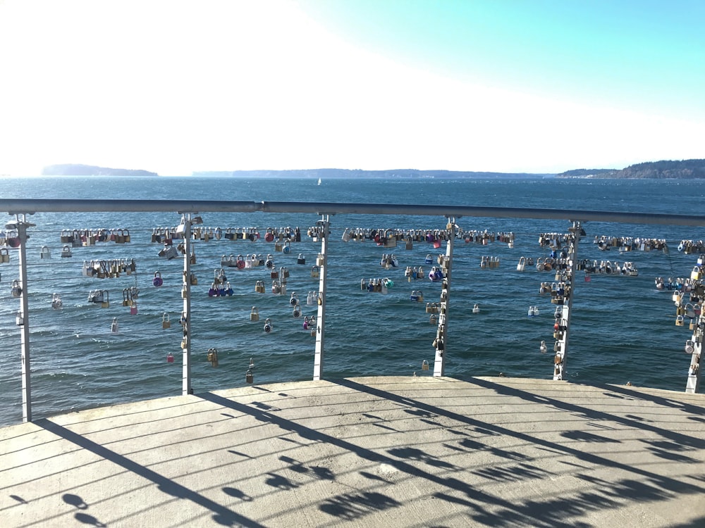 a pier with lots of people swimming in the water