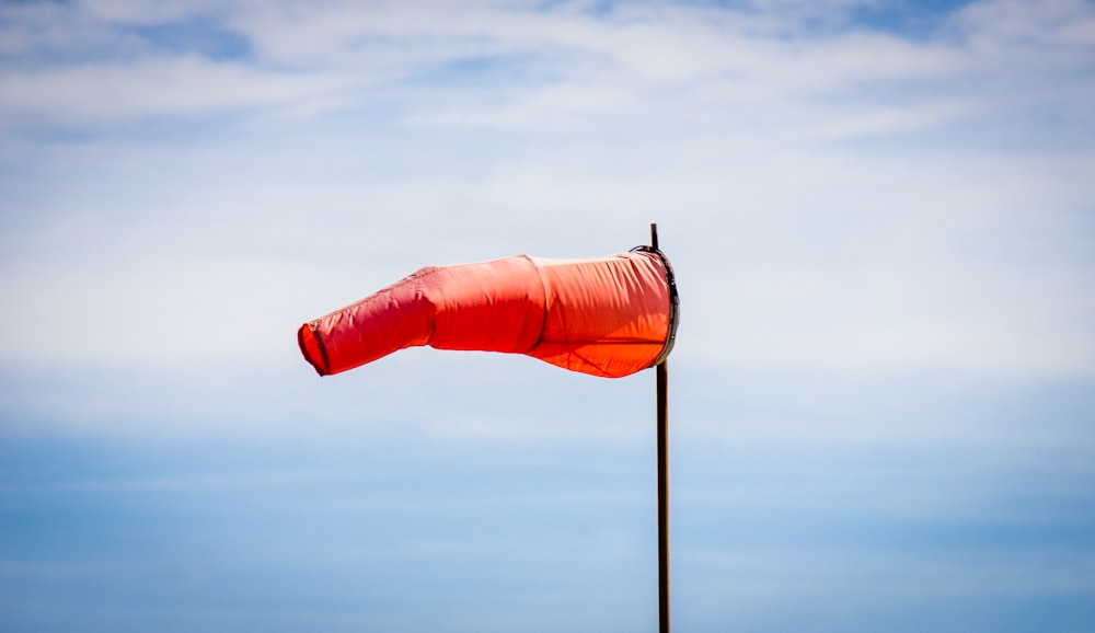 a red kite is flying in the sky