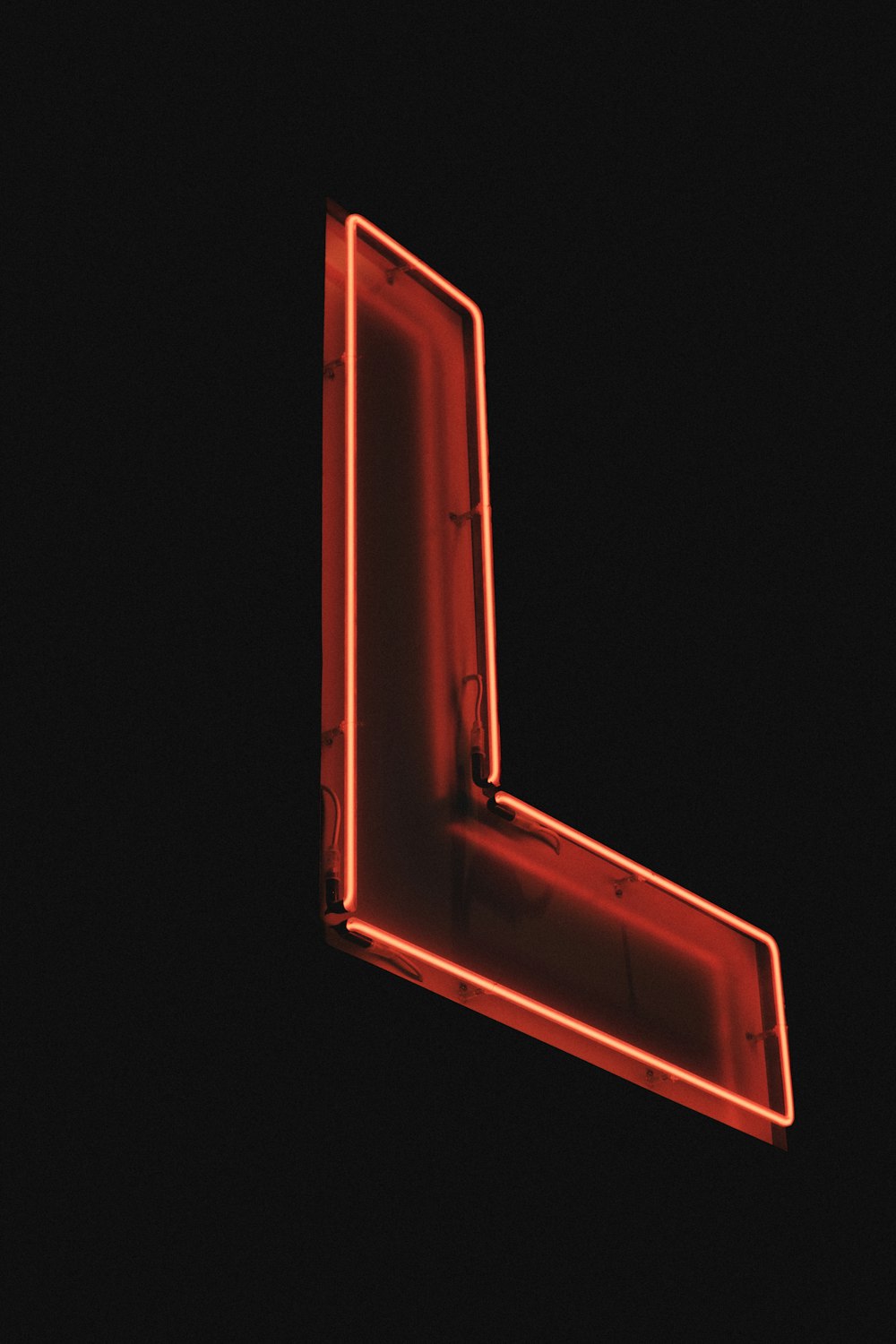 a red neon sign on the side of a building