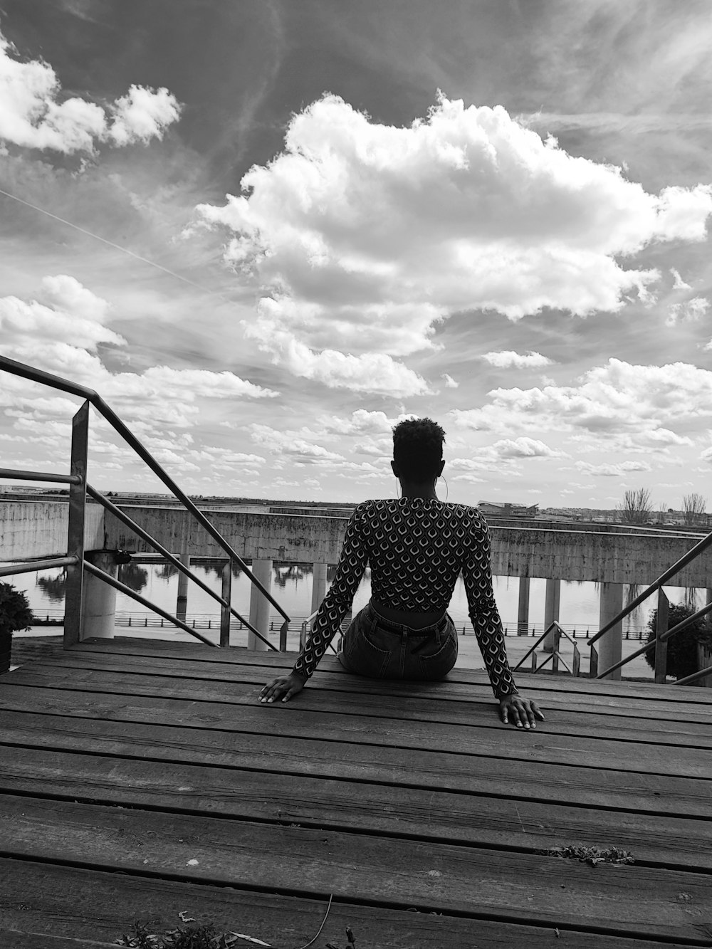 a man is sitting on a wooden deck