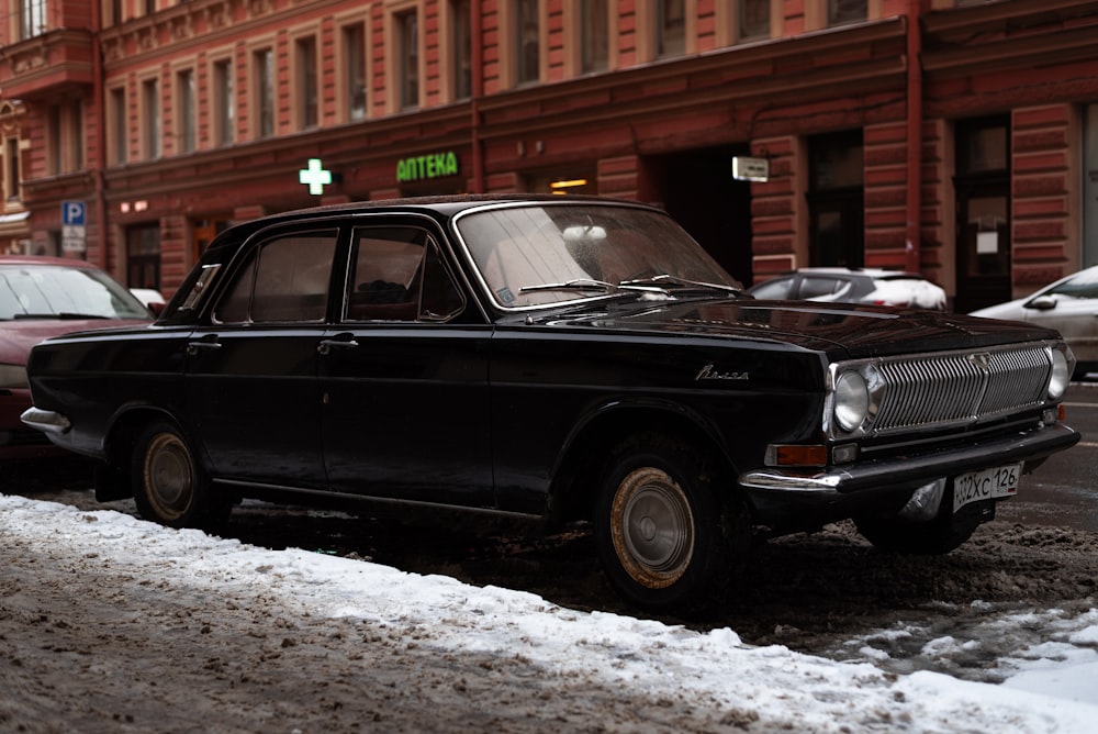 a black car parked on the side of the road