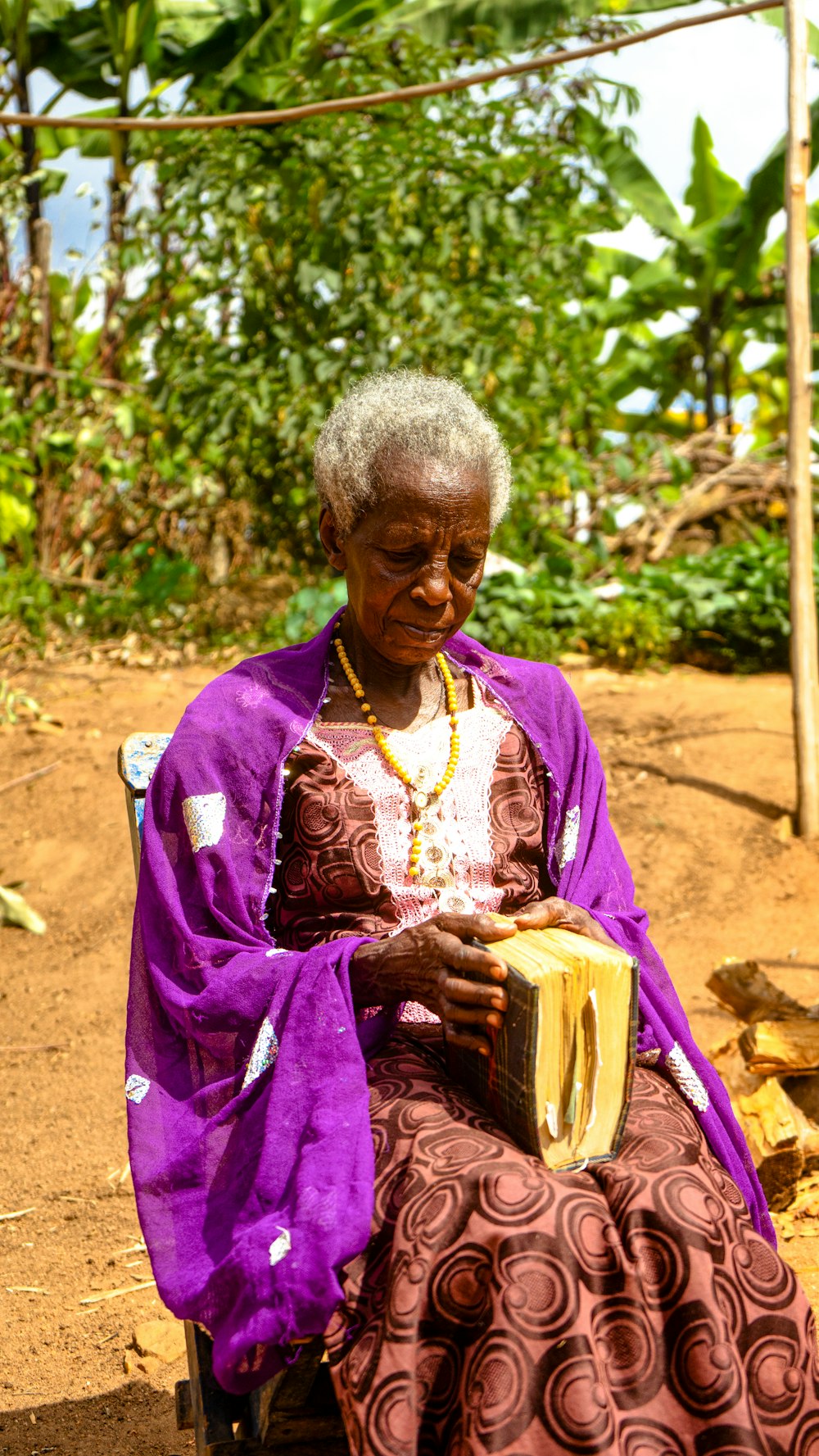 a woman sitting in a chair holding a musical instrument