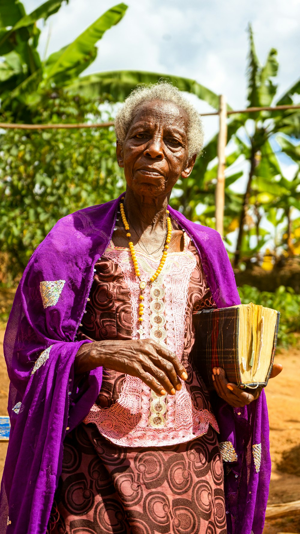a woman in a purple dress holding a cup