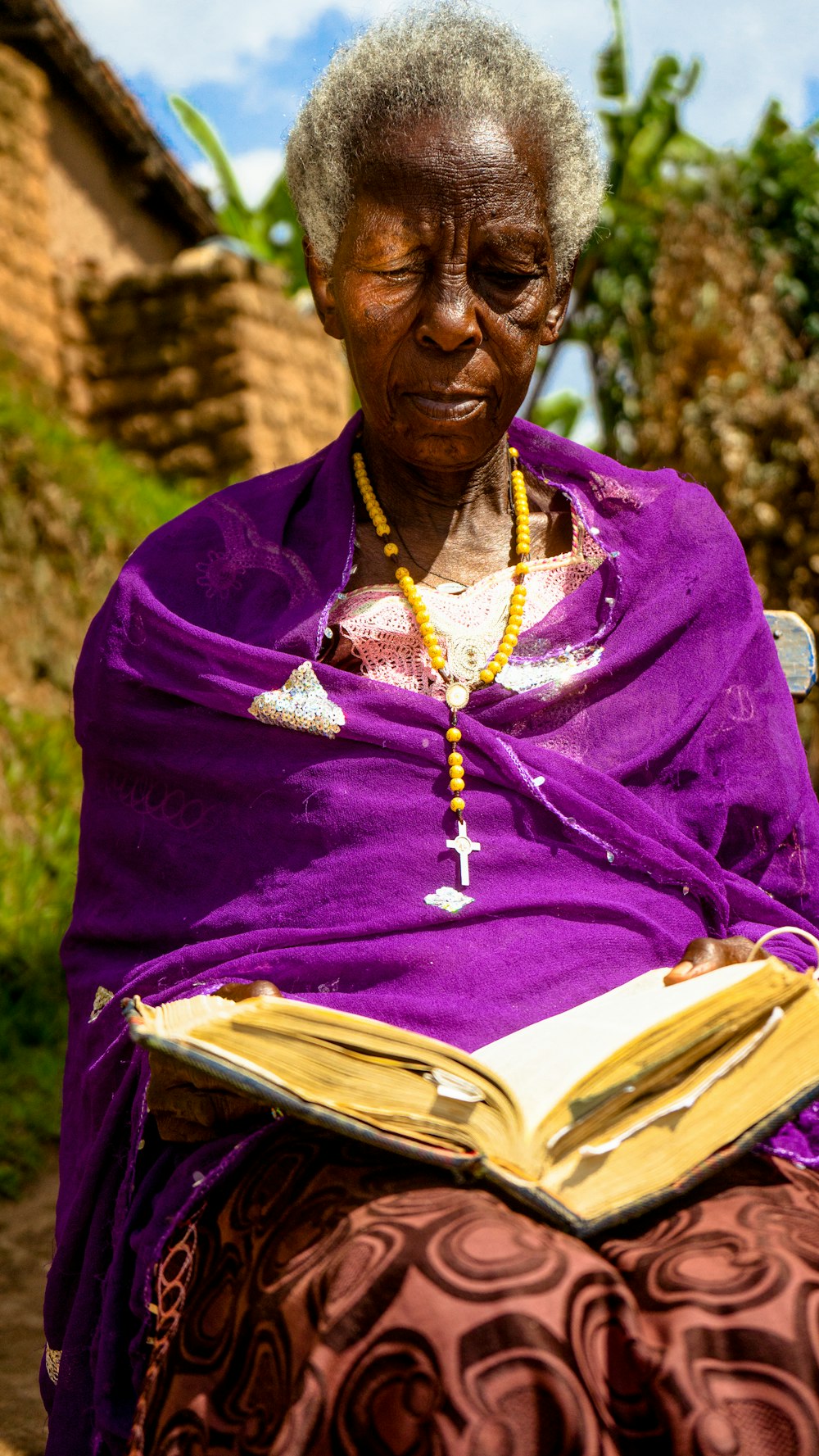 a woman in a purple dress is reading a book
