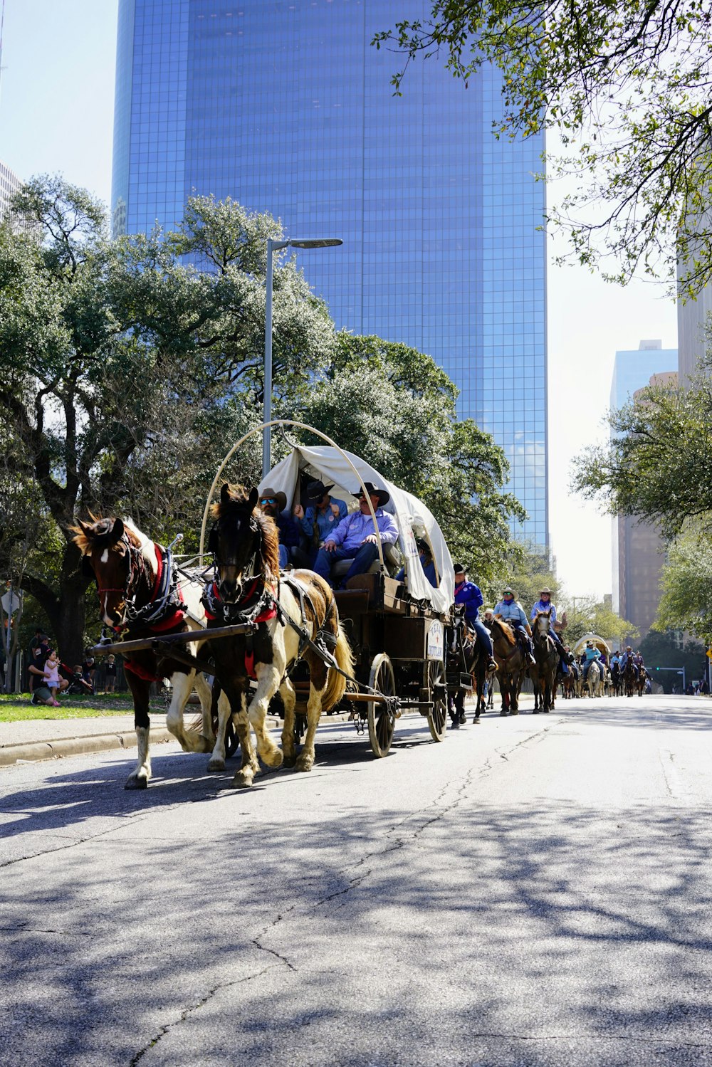 a group of people riding in a horse drawn carriage