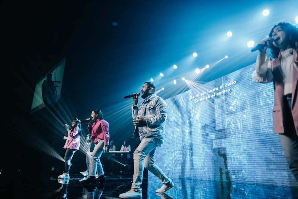 a group of people standing on top of a stage