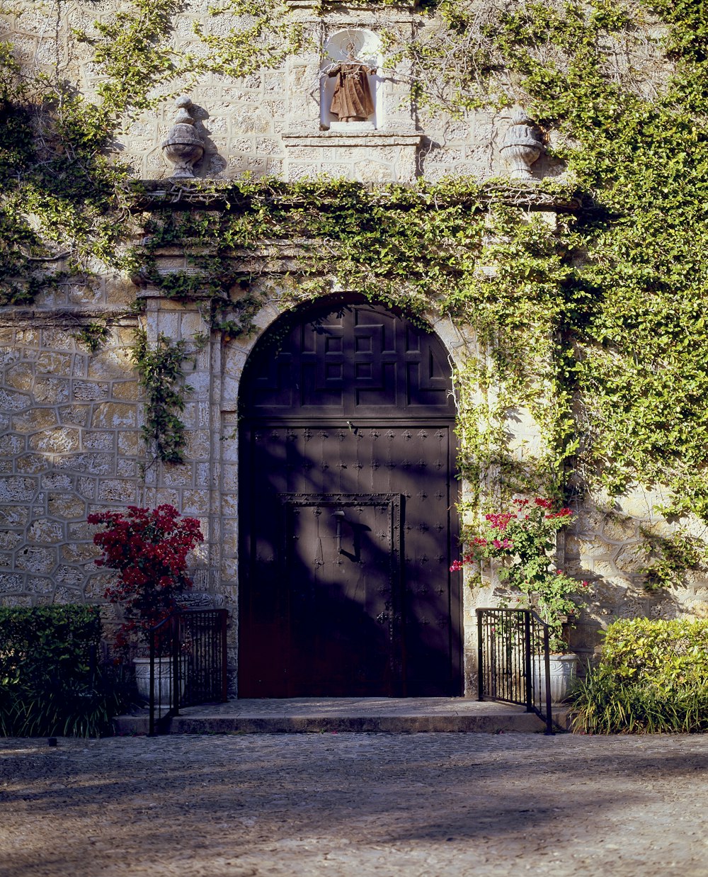 a building with a black door and a black gate