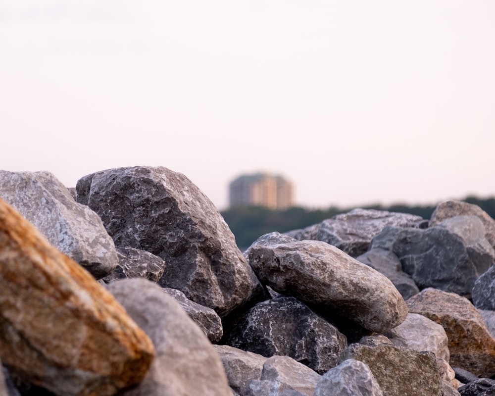 a pile of rocks with a city in the background