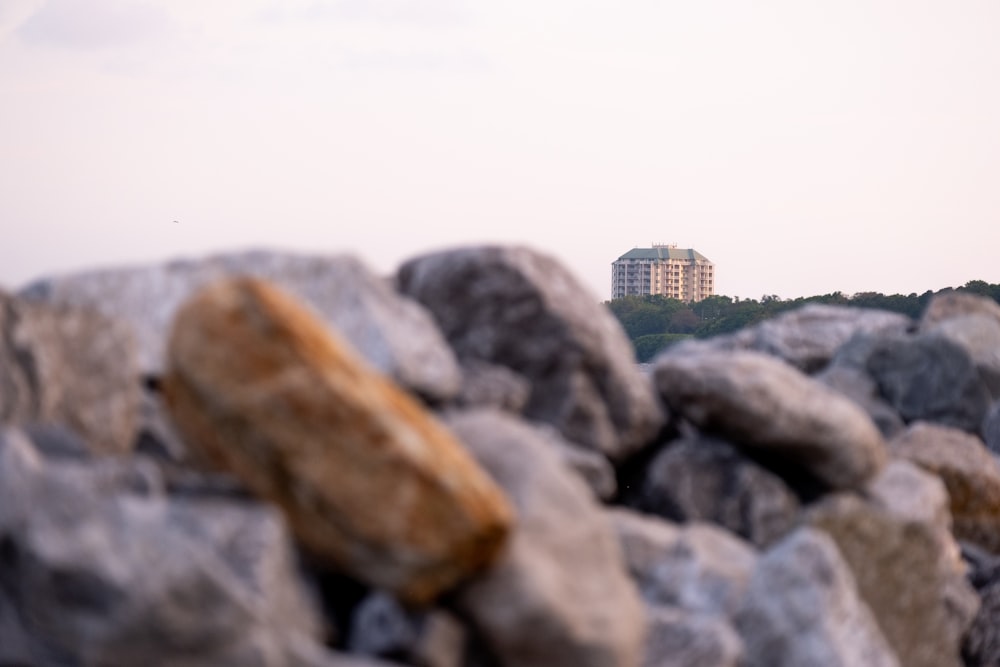a view of a building in the distance from a pile of rocks